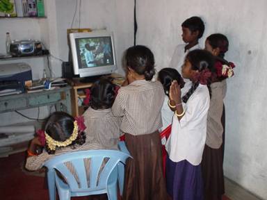 Figure 1: Young children at one of the centres expressing their amazement at the computer by worshipping it with folded hands